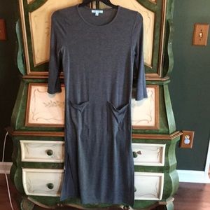 Gray dress with pockets and slits on both sides.